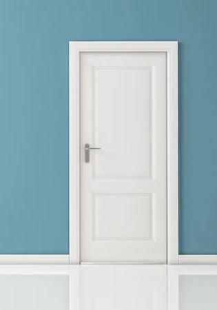 a door with a white door and a blue wall