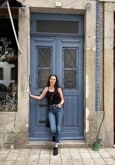 a woman standing in front of a blue door