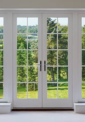 a room with a large window and a view of a field