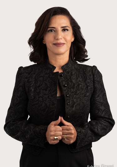 a corporate woman in a black jacket and a ring on her finger