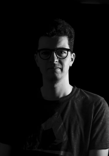 a man in glasses and a black shirt