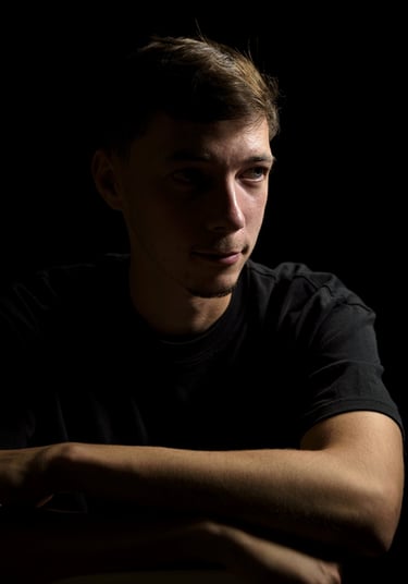 a man in a black shirt is holding a cell phone