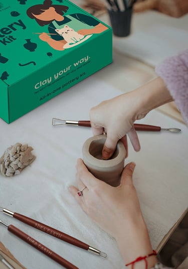 Hands shaping clay in a pottery workshop with Nira Earth Canada pottery kit