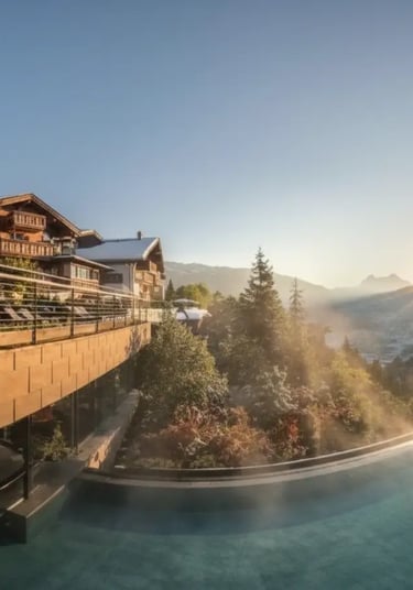 Steaming outdoor infinity pool at a 5-star Val Gardena wellness resort during a golden hour sunset i