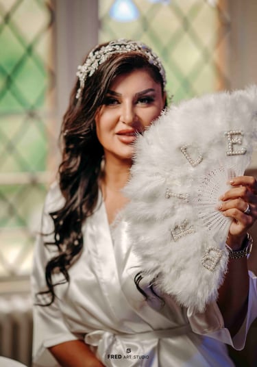 Bride holding white fan in bridal robe – elegant Oxford wedding photography by Fred Art Studio
