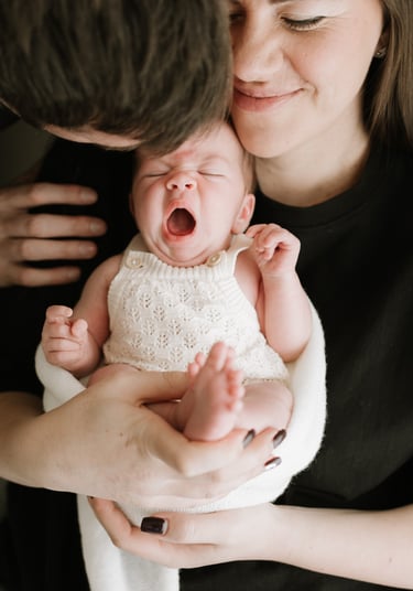 Family cuddling newborn during Adelaide newborn photography session
