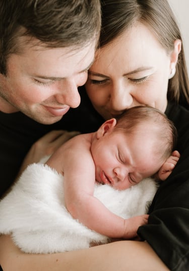 Mother holding newborn during relaxed Adelaide Hills newborn photography session