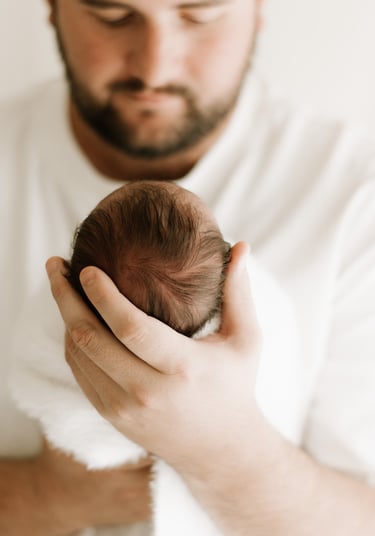 newborn photography Adelaide capturing dad holding baby naturally