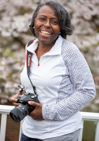 Black woman photographer holding camera in Fort Washington Maryland