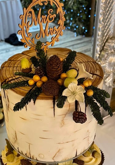 a wedding cake with a wooden sign that says mr and mrs