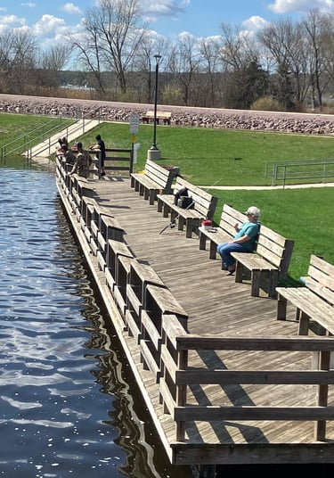 A woman watches the Fox River from a fishing dock in Montello, Wisconsin