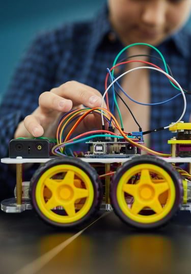 a girl is holding a arduino car