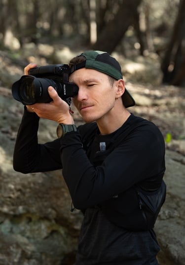 a man taking a picture of himself in the woods