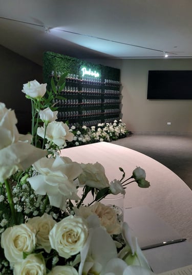 3x champagne walls with 145 champagne flutes a drunk in love neon sign and a floor floral arrangemen