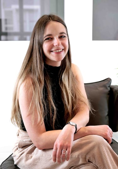 a woman sitting on a couch with and smiling