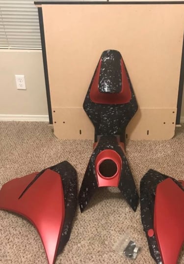 motorcycle bodywork wrapped in red and forged carbon wrap. for a ktm 390