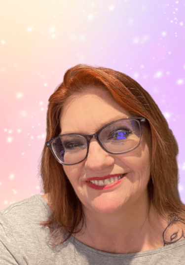 a woman with glasses and a grey shirt
