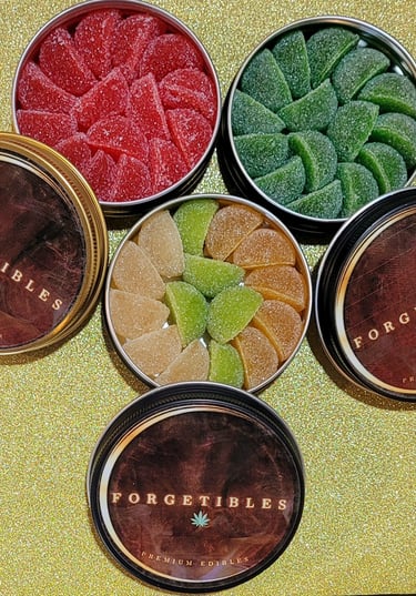 4 round tins with colorful cannabis gummies inside