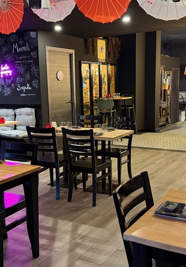 a restaurant with tables and umbrellas and umbrellas