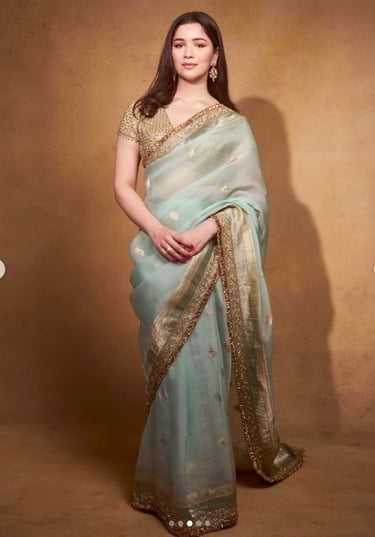 Sara Tendulkar wearing a light mint green saree with a rich golden border, styled with a gold blouse and traditional earrings