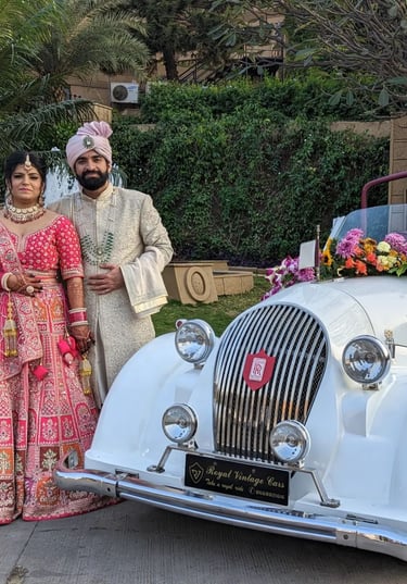 a man and woman in traditional indian attire posing for a photo
