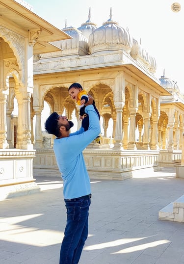 With my toddler at Devi Kund Sagar, Bikaner, surrounded by marble chhatris of royal heritage.