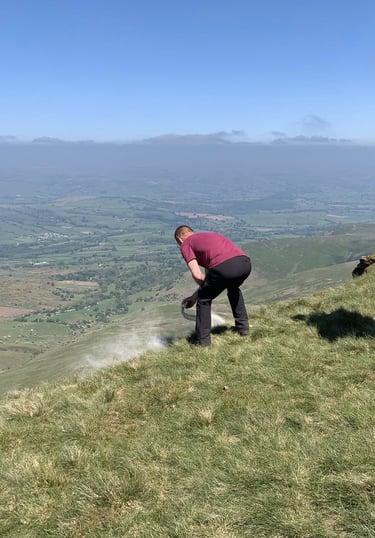 A family member Scattering Ashes, Pen Y Fan, South Wales