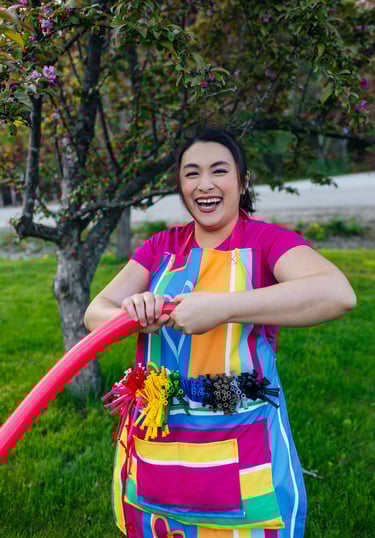 A balloon twister smiling for a photo