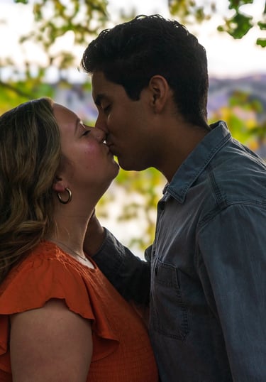 Two people kissing in a romantic setting