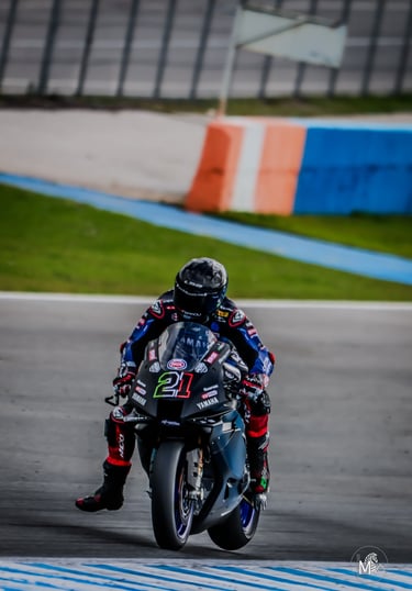 a person riding a motorcycle on a track