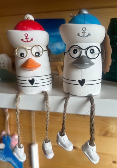two ceramic figurines of two people in a shelf