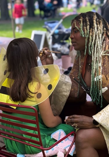 face painting a child at a halloween event