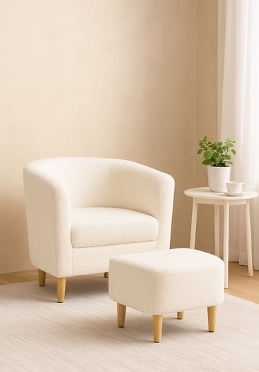 White armchair with ottoman and small side table in a cozy living room
