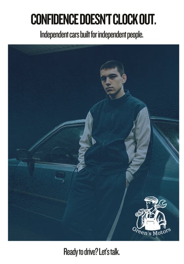 A young man in a tracksuit stands against a blue sedan under harsh petrol station lighting at night.