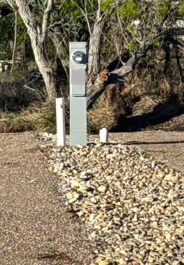 RV Site with meter, water. and clean out in a wooded RV park