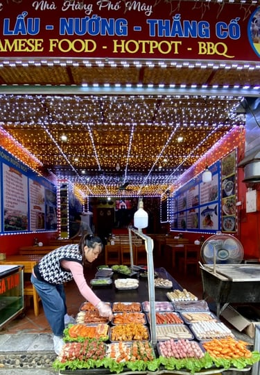 a woman is standing in front of a display of food