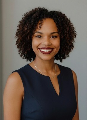 a woman with curly hair and a necklace