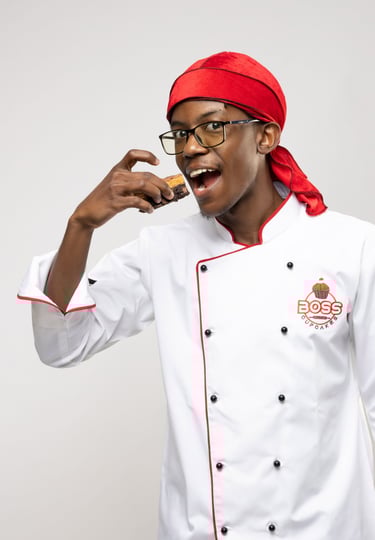 a man in a chef's uniform is holding a cookie