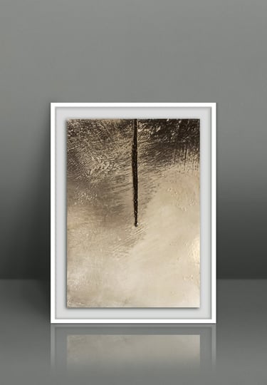 Minimalist gold and bronze abstract painting in a white frame on a grey studio background.