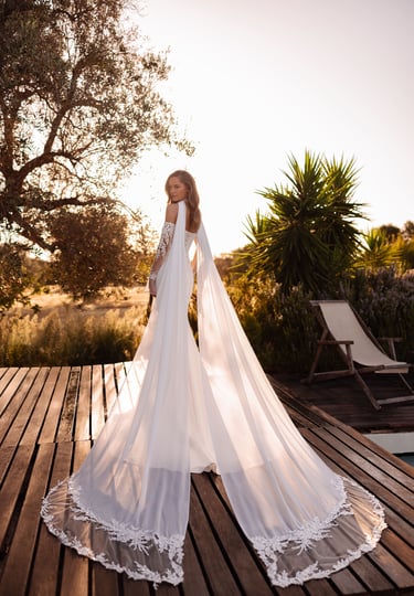 a woman in a wedding dress standing on a deck