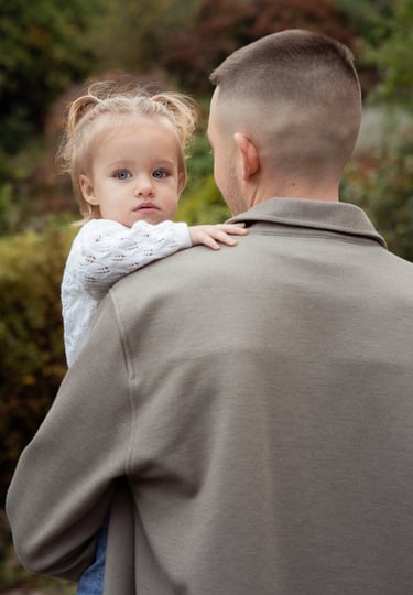 Father holding her baby daughter in his arms