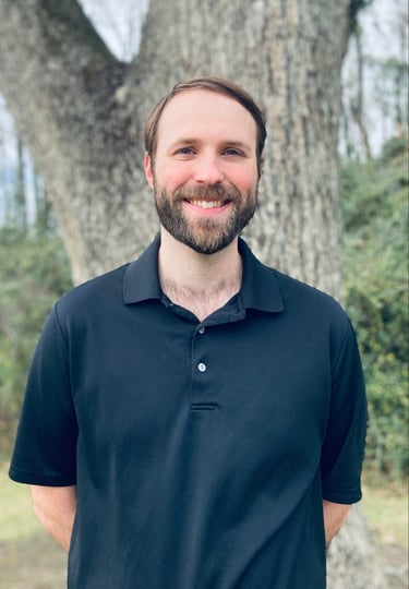 Counselor standing in front of a tree