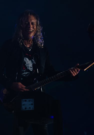 Kirk Hammett with a guitar and a microphone