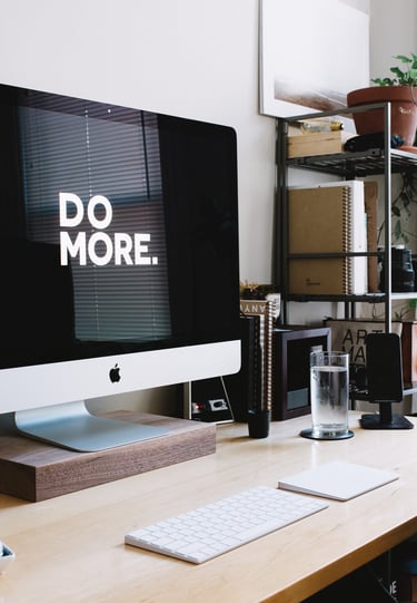 work area. computer screen reads "Do More."