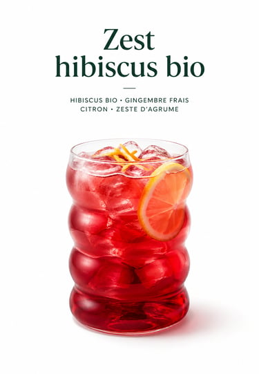 Iced organic hibiscus tea with ginger and lemon zest in a modern glass.