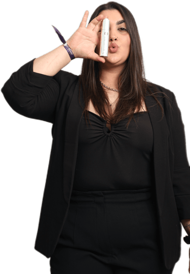 a woman with a rejuvenique oil in her hand