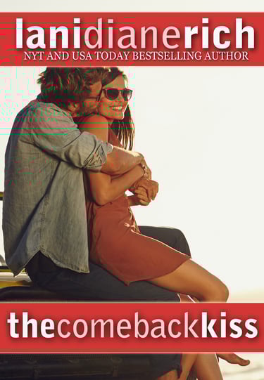 a man kissing a woman's cheek as they sit on the hood of a car