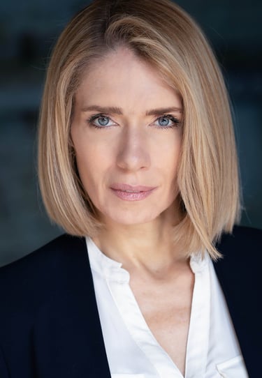 a woman with blonde hair and a white shirt
