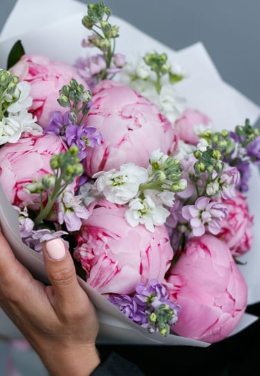 a girl holding a bouquet of flowers in the hands