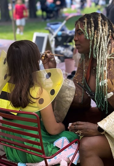face painting a child at a halloween event